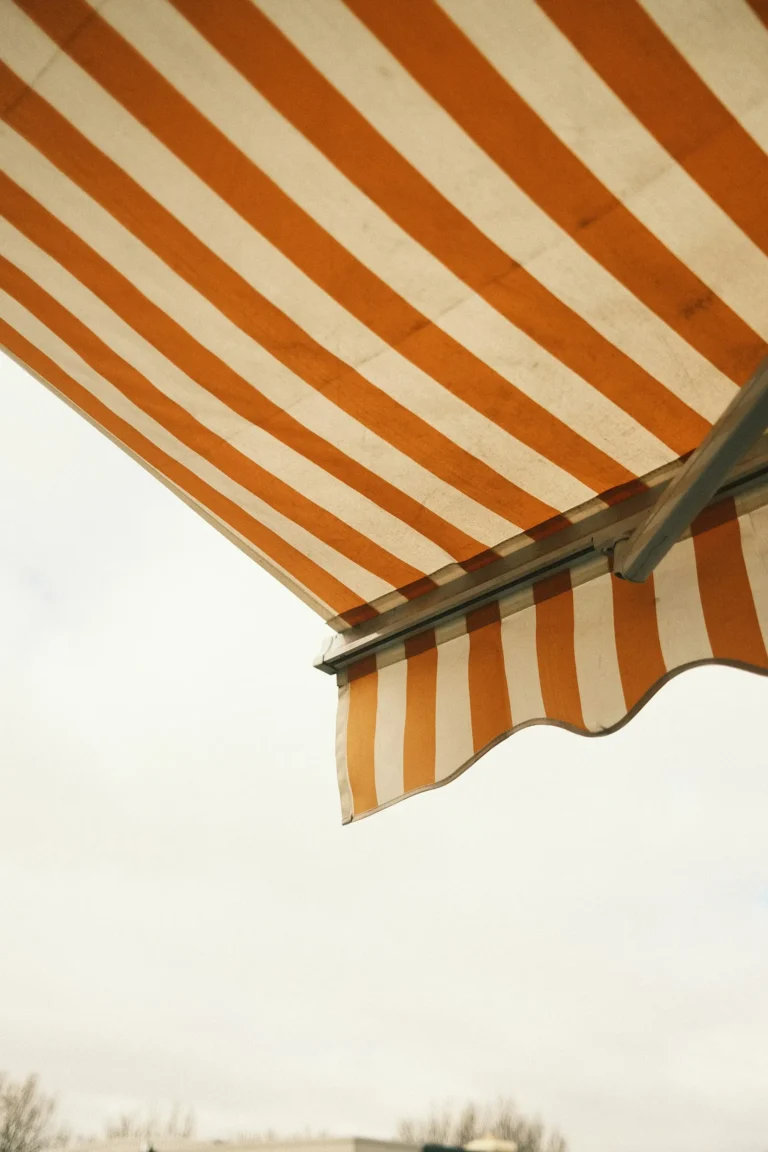 Striped canvas awning with scalloped valance